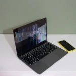 Laptop screen showing code with black line reflection, illustrating what causes black lines on laptop screen